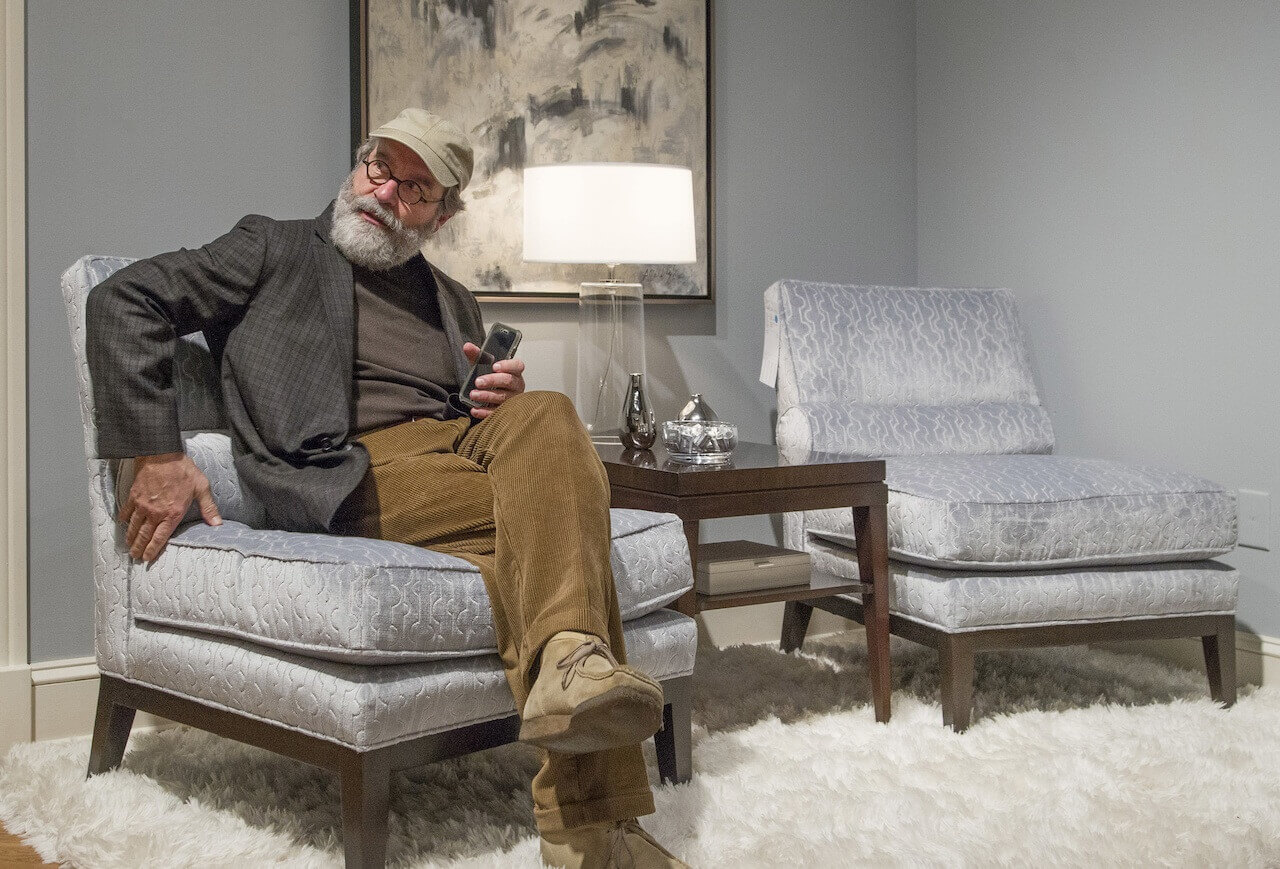 ...and sits on every chair or couch he's considering for his store.