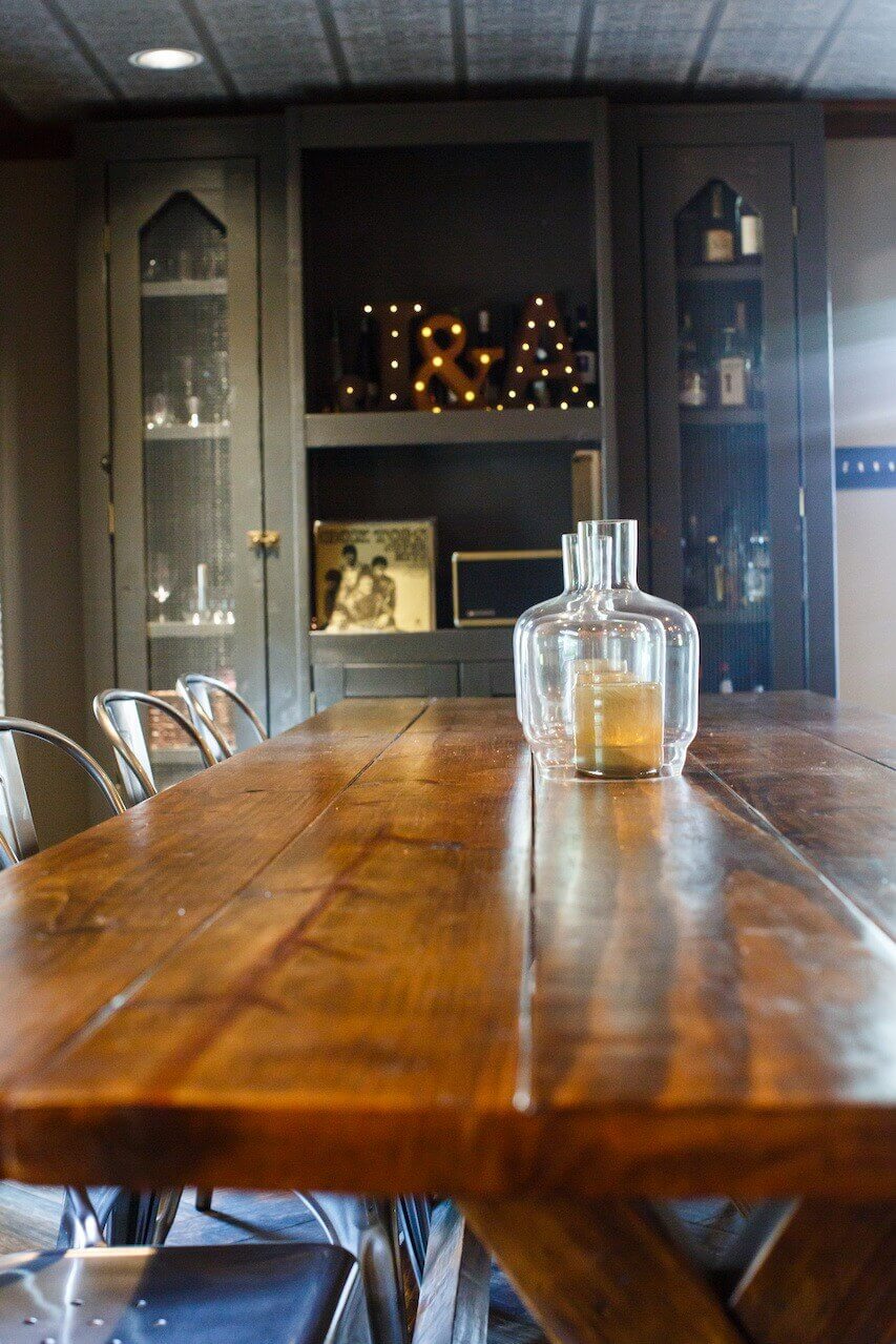 The opposite end of the dining room features a built-in bar area with clever open storage for liquor bottles and glassware. The opposite end of the dining room features a built-in bar area with clever open storage for liquor bottles and glassware.