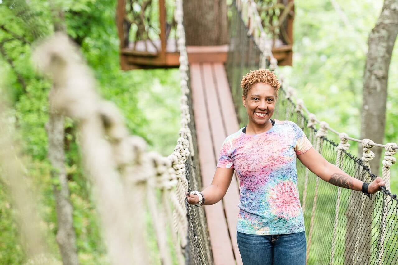Olivia on a swinging bridge in the Hugh Kaul Beanstalk Forest at Red Mountain Park