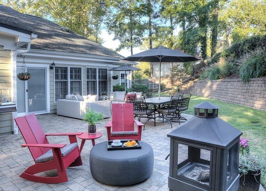 The red rockers really pop in the decor. outdoor rocking chairs create an inviting space