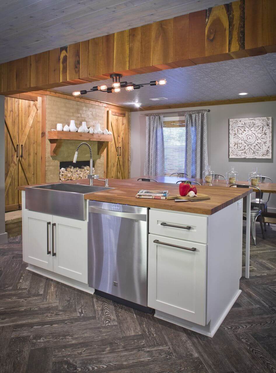 "We wanted plenty of storage with everything put away, and we wanted a deep sink," says Justin. Barn doors on the fireplace wall behind the island hide additional storage space. Image| "We wanted plenty of storage with everything put away, and we wanted a deep sink," says Justin. Barn doors on the fireplace wall behind the island hide additional storage space. Image|