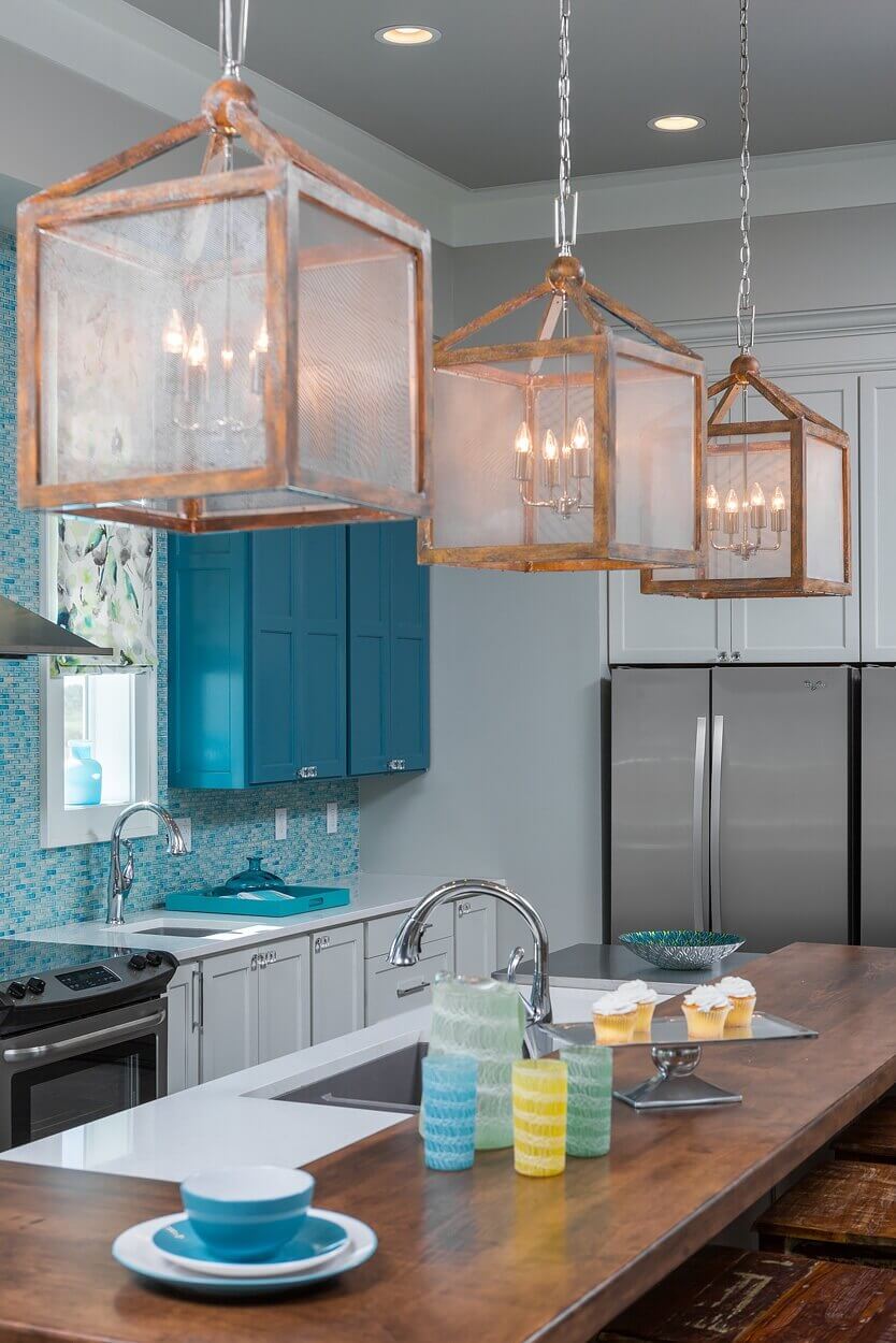 Old World-style lanterns were selected for above the island partly because of their visual weight. “I liked that they were slightly oversized, and I needed the bulk to balance the 11-foot ceilings and large open plan,” interior designer Cheryl Clendenon says, noting that the lantern style also plays into the coastal look. clendenon06.jpgOld World-style lanterns were selected for above the island partly because of their visual weight. “I liked that they were slightly oversized, and I needed the bulk to balance the 11-foot ceilings and large open plan,” interior designer Cheryl Clendenon says, noting that the lantern style also plays into the coastal look.