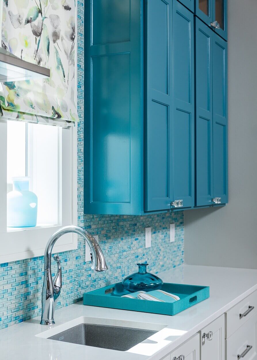 Who says everything needs to match? A single teal cabinet livens up the kitchen corner. Glass knobs go well with the backsplash made of glass tiles. Who says everything needs to match? A single teal cabinet livens up the kitchen corner. Glass knobs go well with the backsplash made of glass tiles.