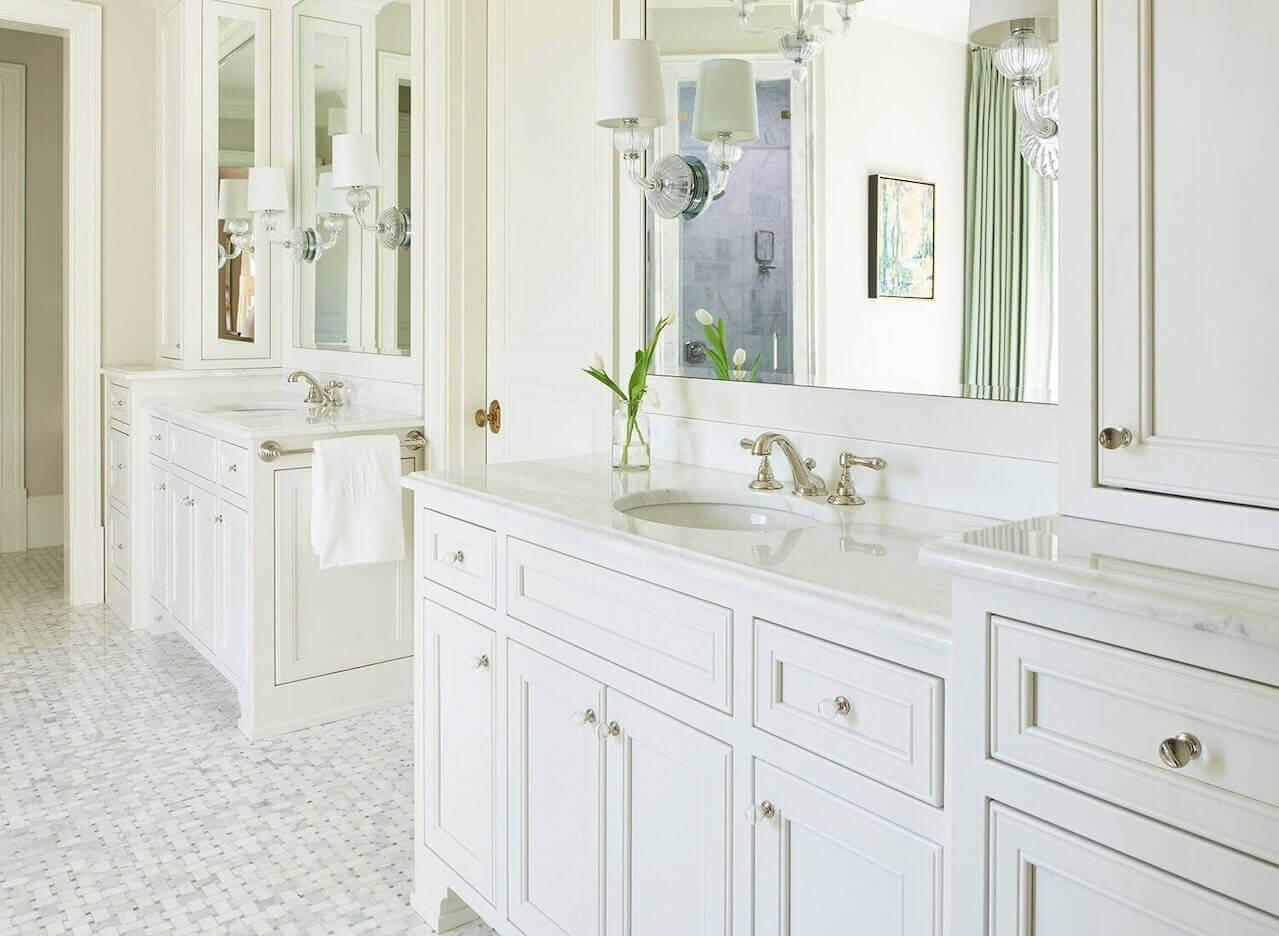 His-and-her custom vanities feature ample storage.