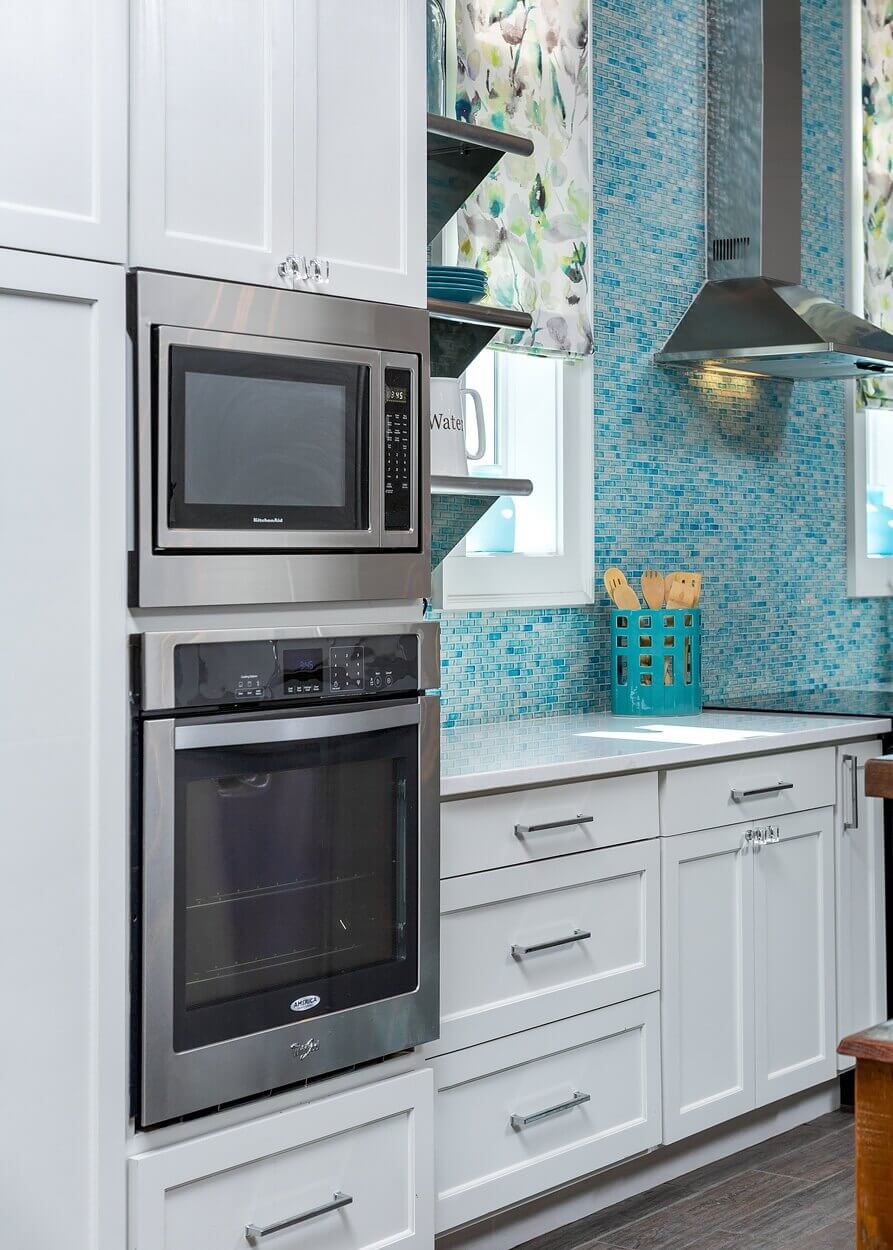 Inexpensive appliances are built in to the cabinetry for a high-end look. Inexpensive appliances are built in to the cabinetry for a high-end look.