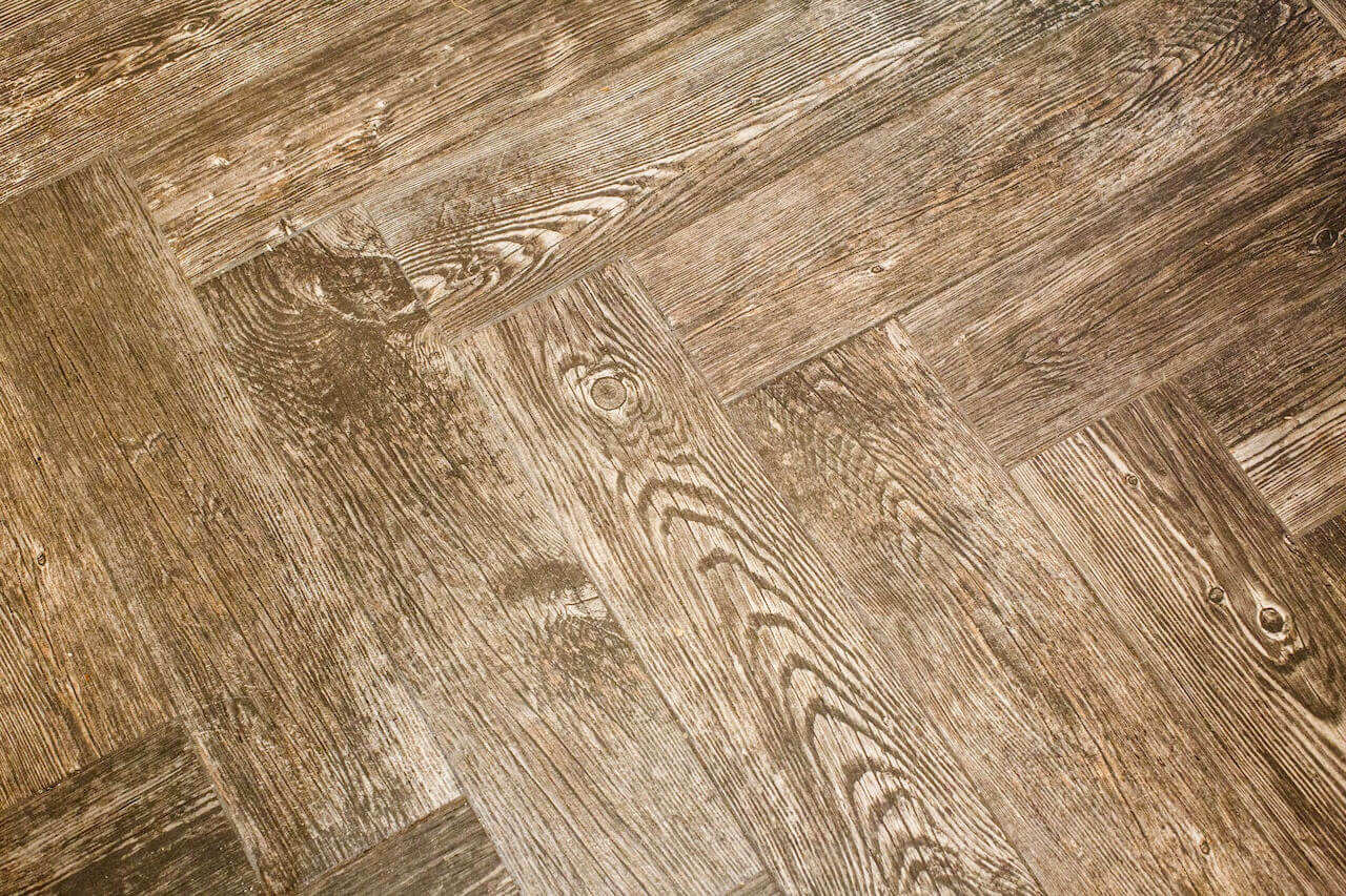 The wood floor's chevron pattern adds another dash of interest to the kitchen and dining area. The wood floor's chevron pattern adds another dash of interest to the kitchen and dining area.
