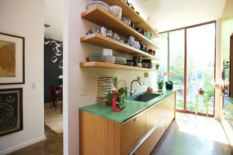 The kitchen displays many of the home's eco-friendly features, such as the bamboo millwork and cabinetry and recycled resin, or three-form, serves as a countertop and backsplash in the kitchen. The kitchen displays many of the home's eco-friendly features, such as the bamboo millwork and cabinetry and recycled resin, or three-form, serves as a countertop and backsplash in the kitchen.