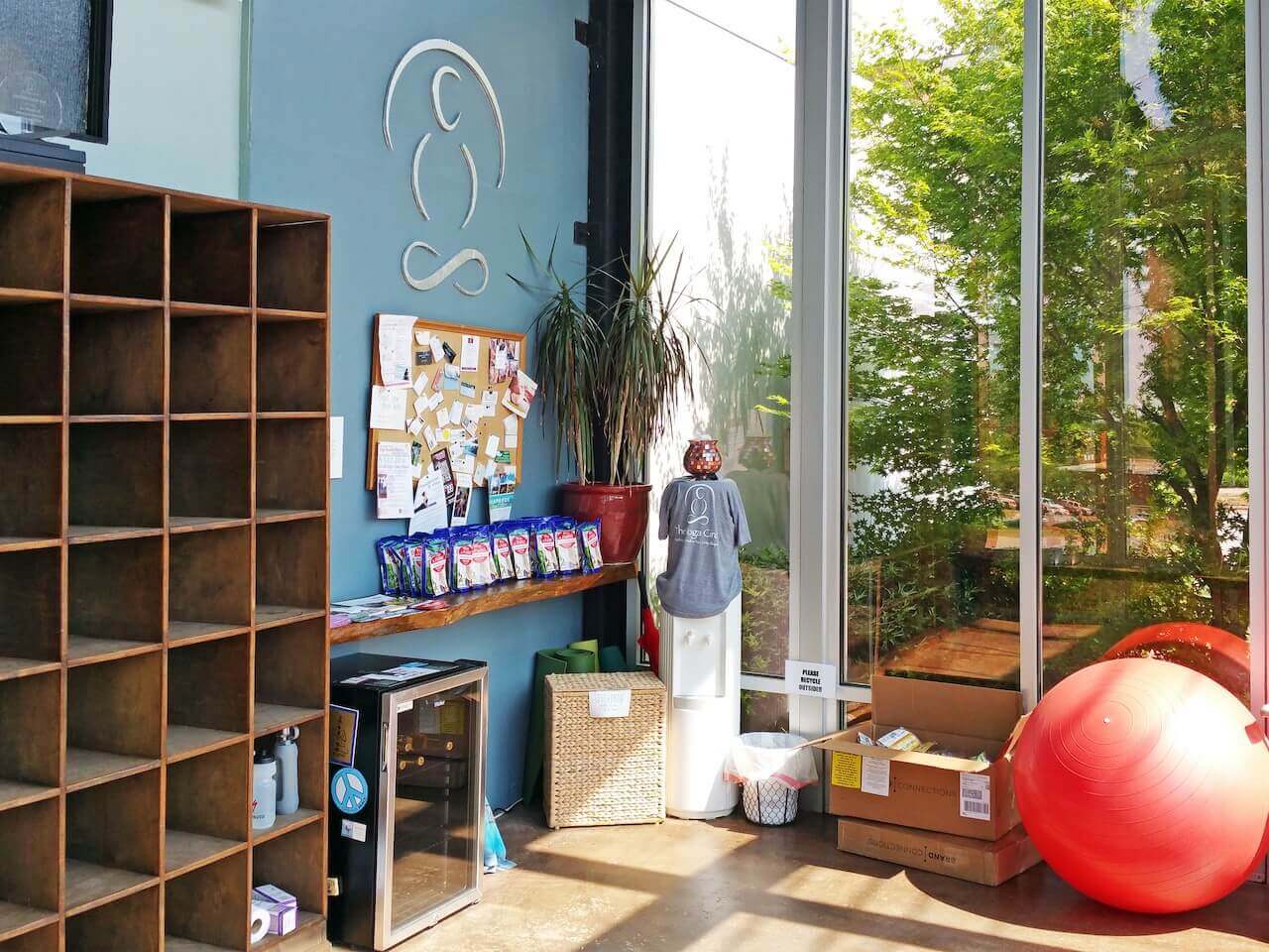 The large, airy sunroom studio at The Yoga Circle has cubbies, water and energy snacks, as well as an exercise ball and weights.