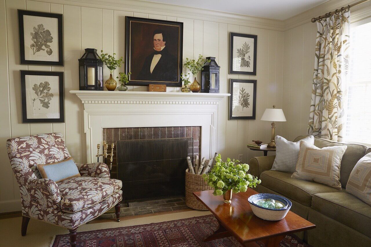 Family antiques fill the study, a favorite place for adults to retreat in the evening. Painting the bookcases, fireplace mantle and walls in a creamy beige warmed up the room without making it too dark and moody, adds Hennessy.  The color was chosen from the crewel curtains that the previous owners left behind.