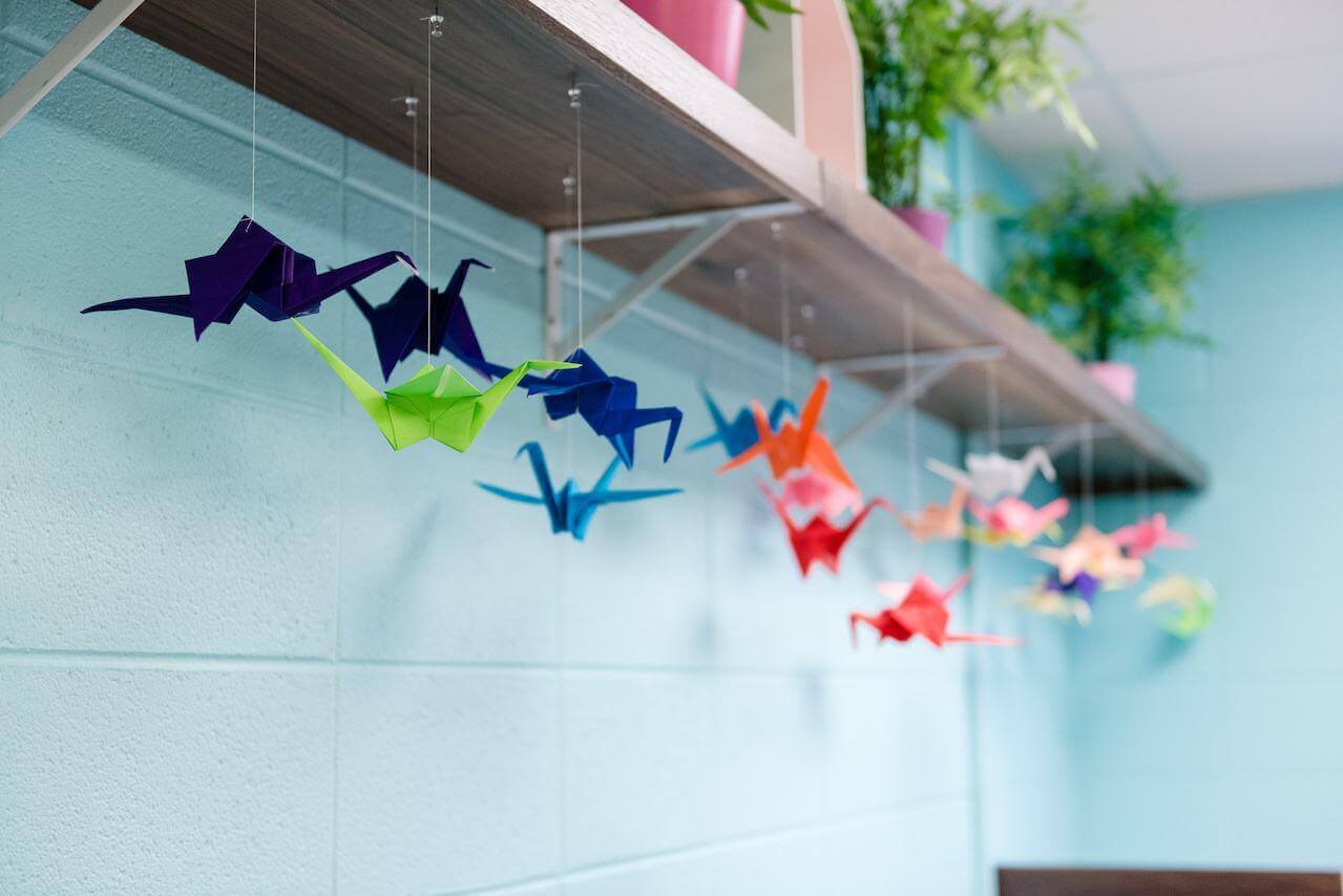 A colorful vignette of hanging origami swans at the Girls Inc. facility