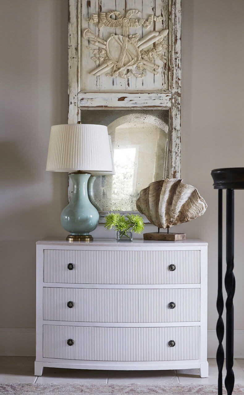 "I love the chipped up old painted mirror for this beach house foyer. We chose a soft green lamp to set the tone for the room. And of course every beach house need a old clam on a stand," says Libby with her trademark sense of humor. "It was one of the first purchases we made on the renovation." "I love the chipped up old painted mirror for this beach house foyer. We chose a soft green lamp to set the tone for the room. And of course every beach house need a old clam on a stand," says Libby with her trademark sense of humor. "It was one of the first purchases we made on the renovation."