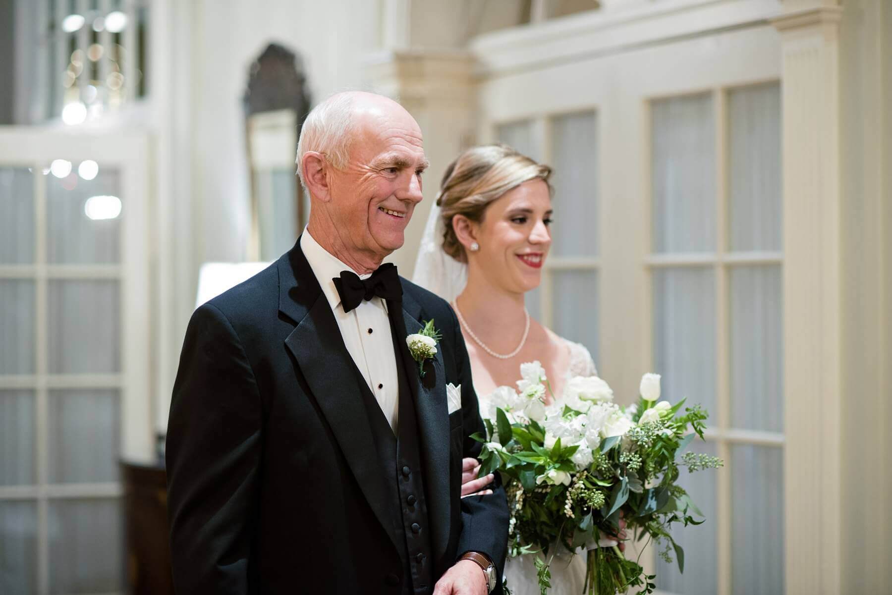 Clem's dad proudly walks her down the aisle.
