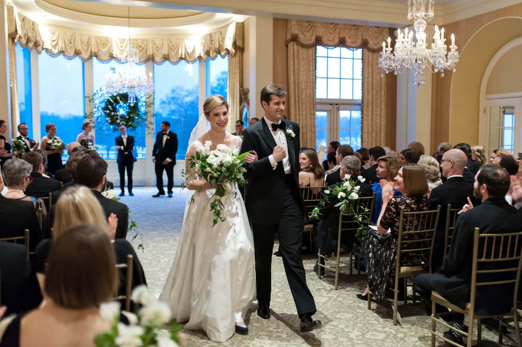 Clem and Charlie depart the wedding ceremony arm-in-arm as husband and wife.