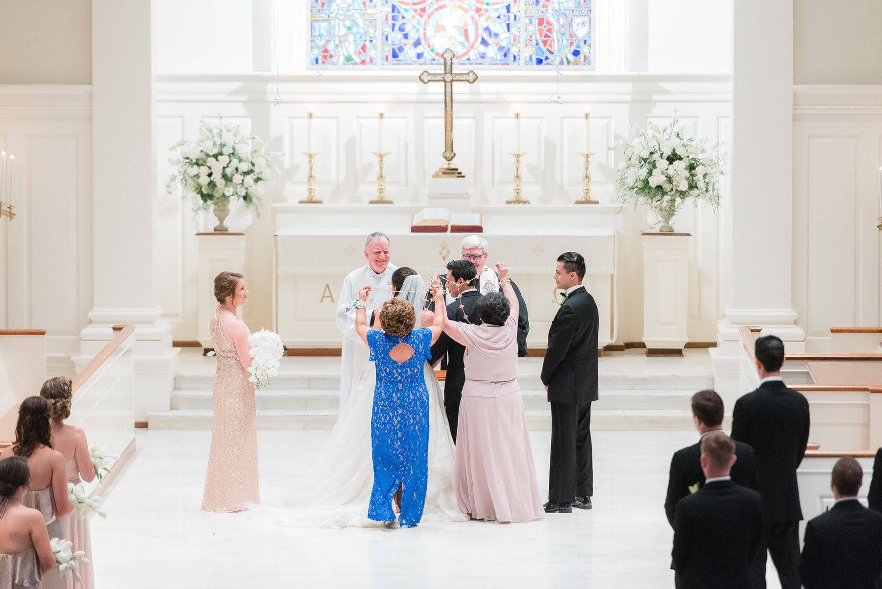 Ashley and Carlos wanted to honor his background by incorporating a traditional lasso ceremony, a prominent Spanish wedding tradition, into their wedding ceremony. Two of Carlos’ aunts were invited up during the ceremony, and they wrapped the wedding lasso, or large rosary, around the bride and groom in the shape of a figure eight, representing eternity and the tying together of the bride and groom.