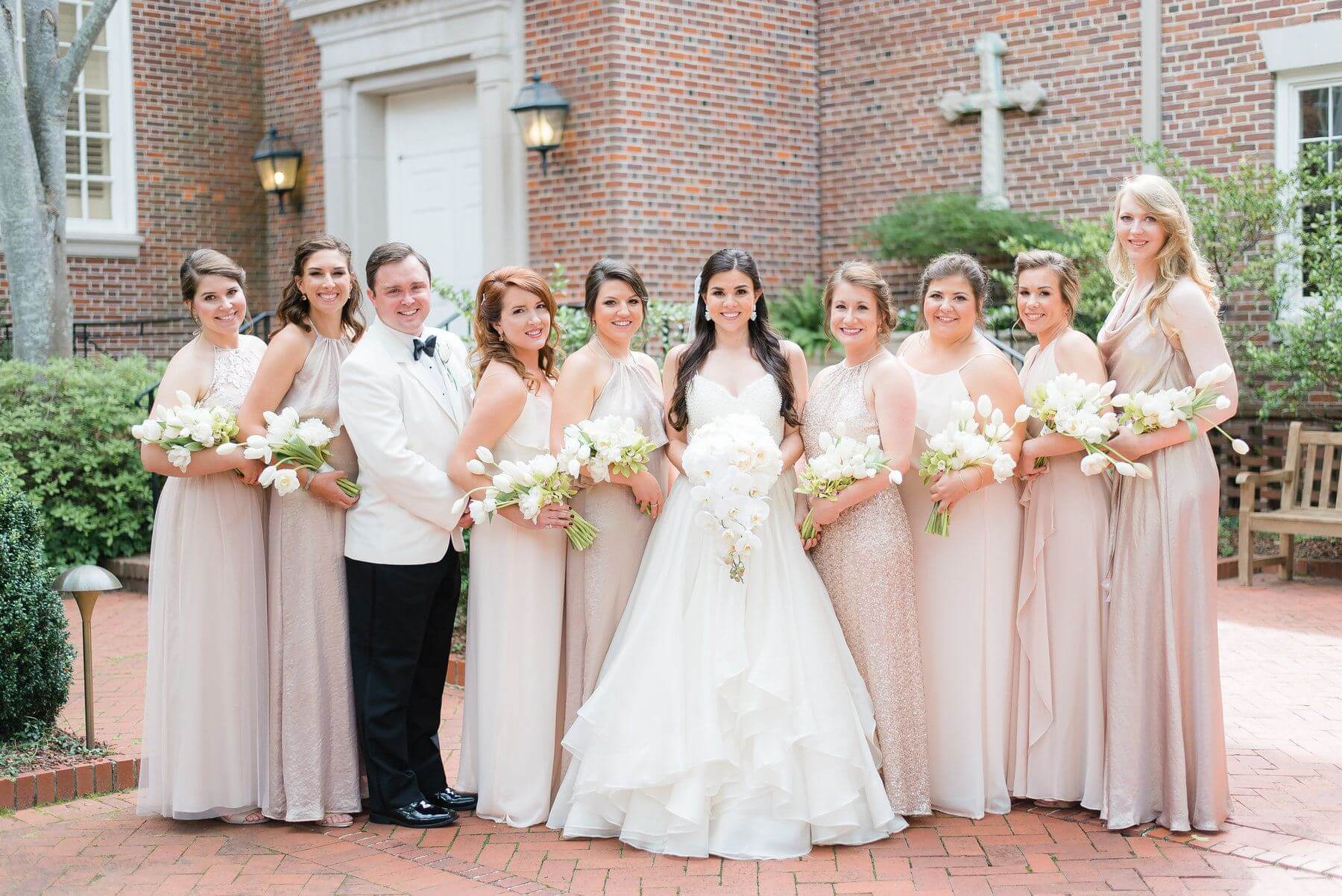 Ashley was such a kind and considerate bride. She says since her friends were doing her a huge favor by being in her wedding, she really wanted them to feel comfortable and beautiful in their dresses. She selected a variety of dresses at Bella Bridesmaids and then told her girls to pick whichever style they felt most beautiful in. We love this thoughtful approach to mix-and-match bridesmaids dresses — and what a gorgeous result!