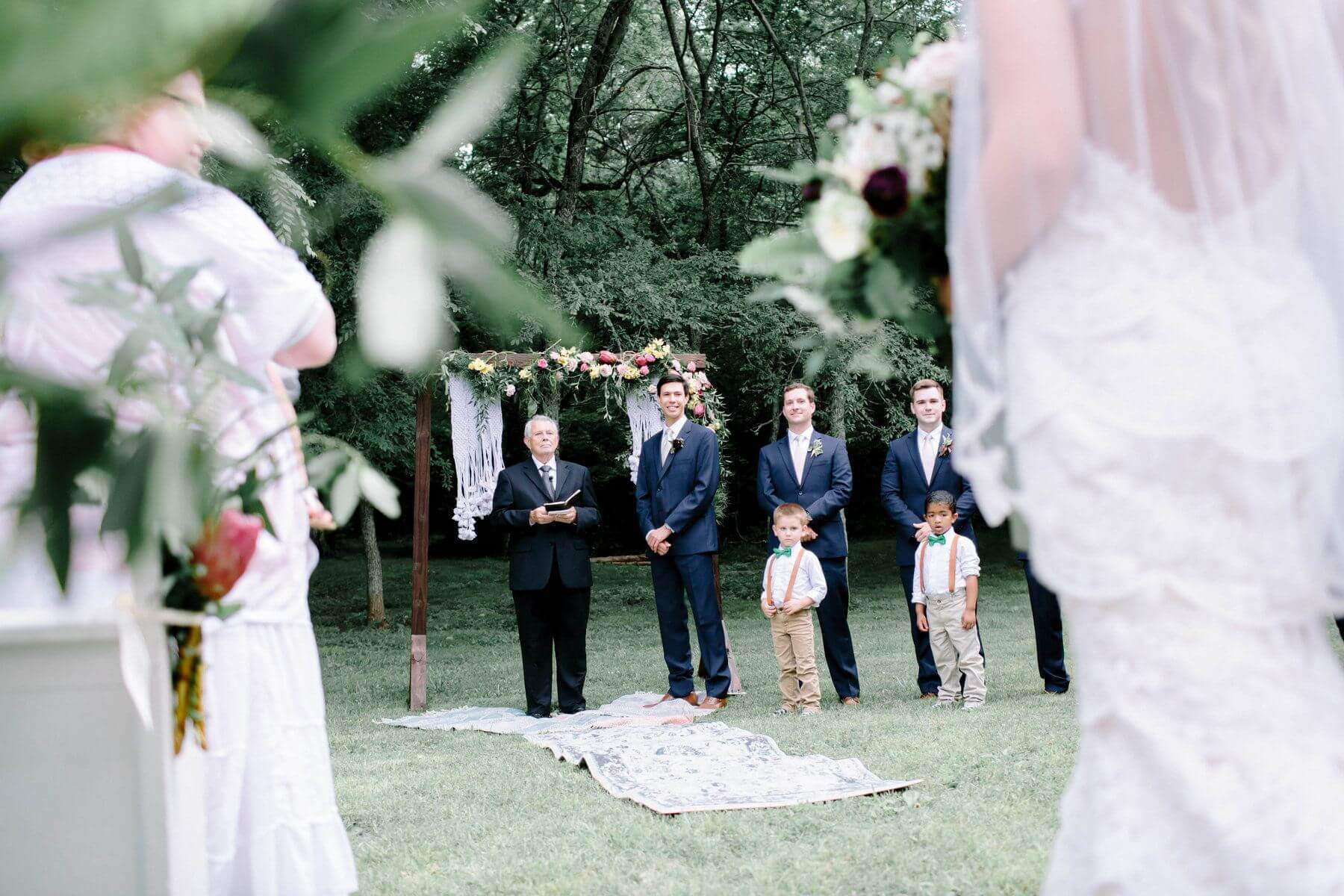 Jonathan gleams as he looks on at his bride-to-be walking down the aisle. romantic bohemian wedding