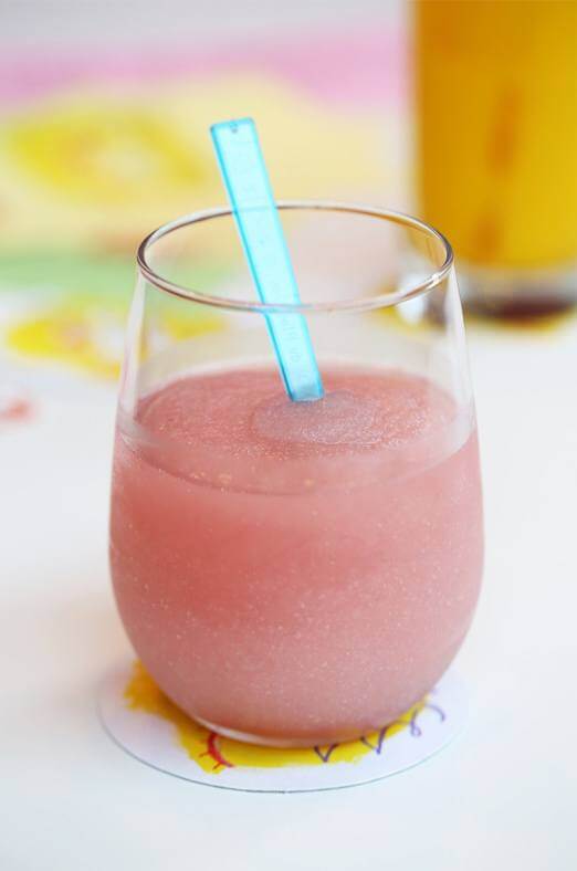 A pink frozen cocktail with a straw