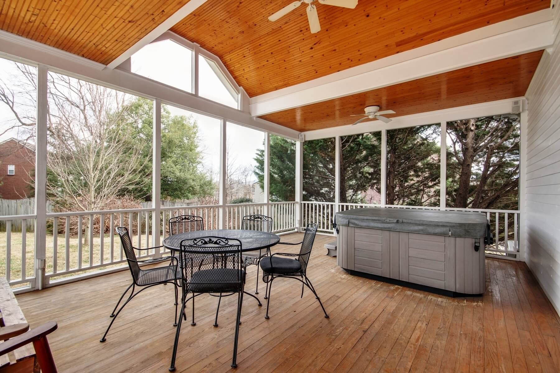 Enjoy a summer meal outdoors in this spacious screened-in porch.