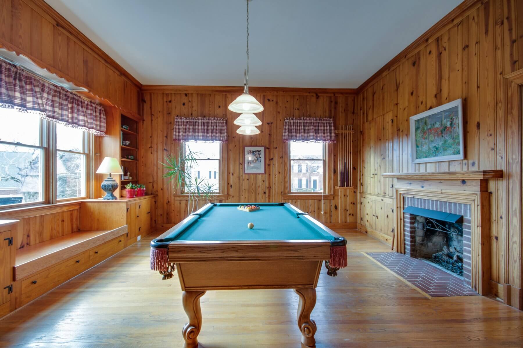 Ample space allows for fun additions, such as a pool table to this recreation room.