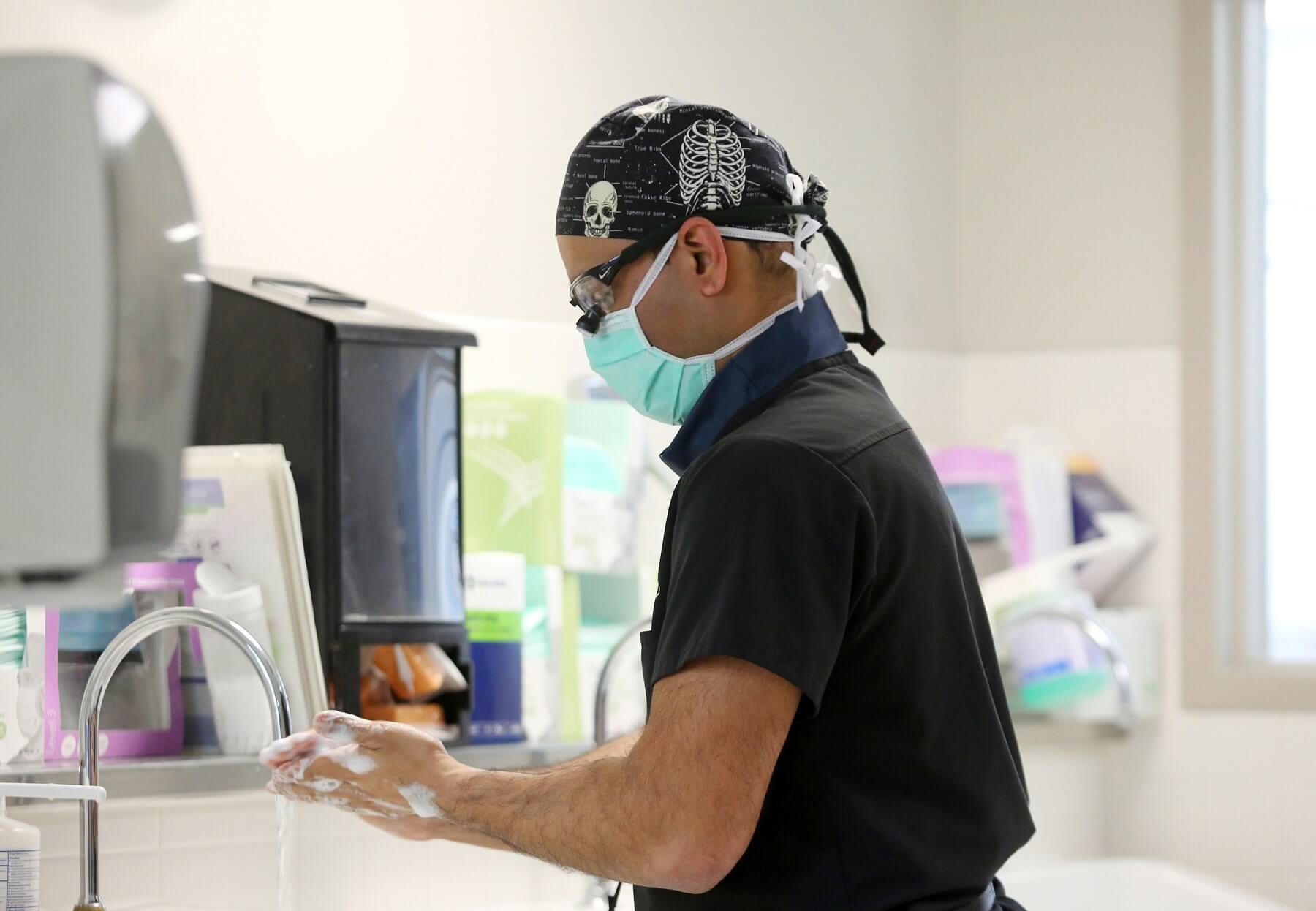 Dr. Patel scrubs in prior to surgery.