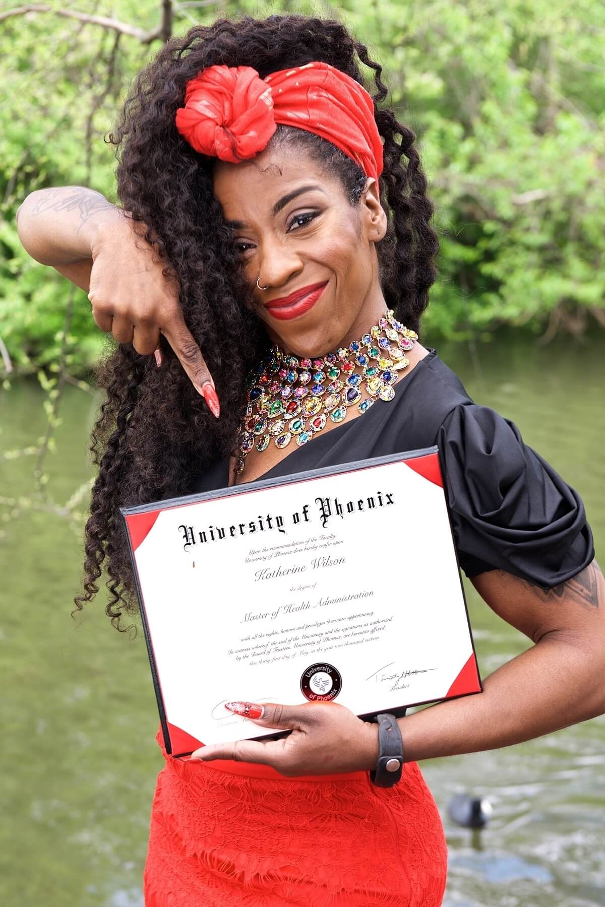Tisha proudly displays her master's degree.