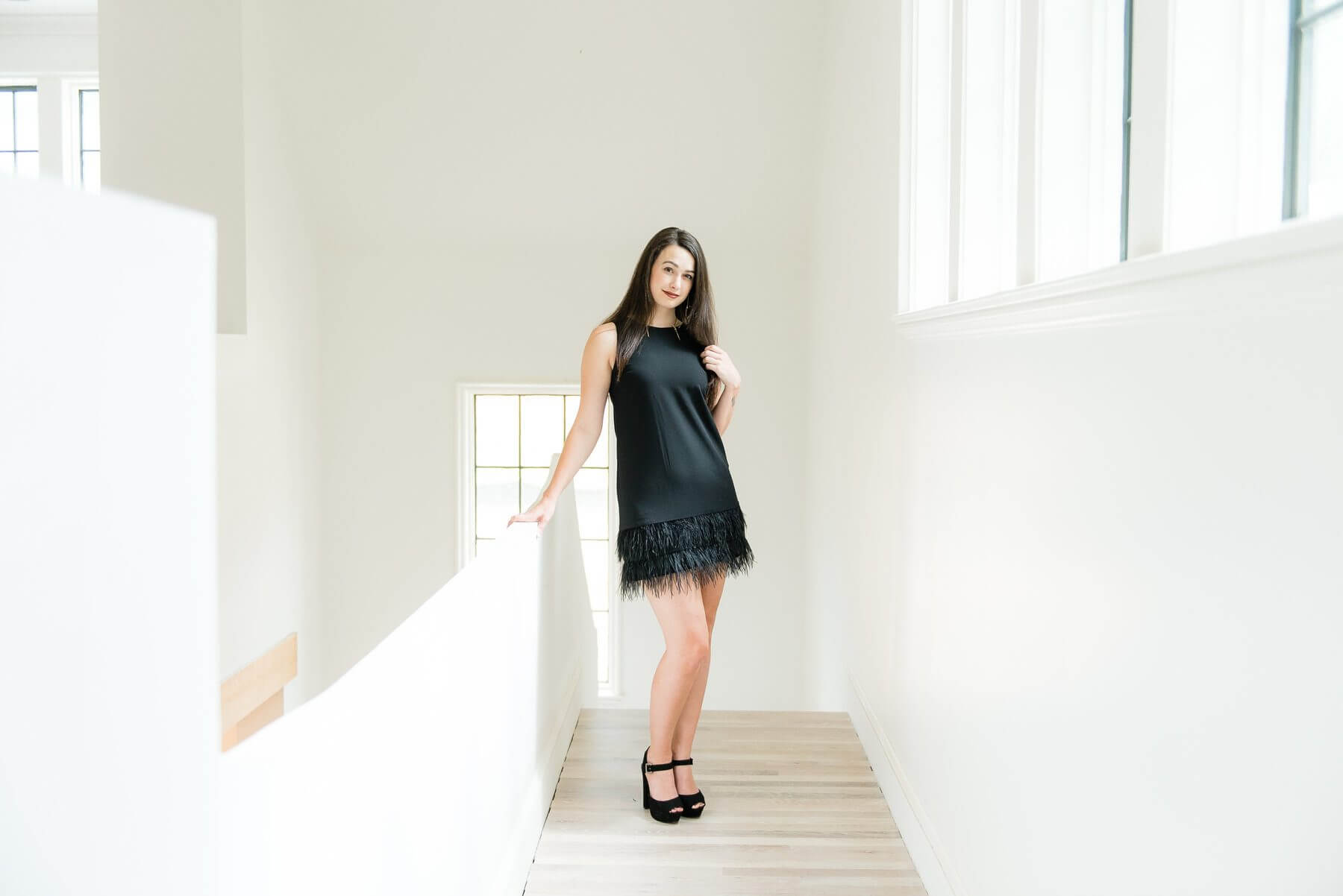 On Taylor from The Clothes Tree by Deborah: Black shift dress with feathers, $275