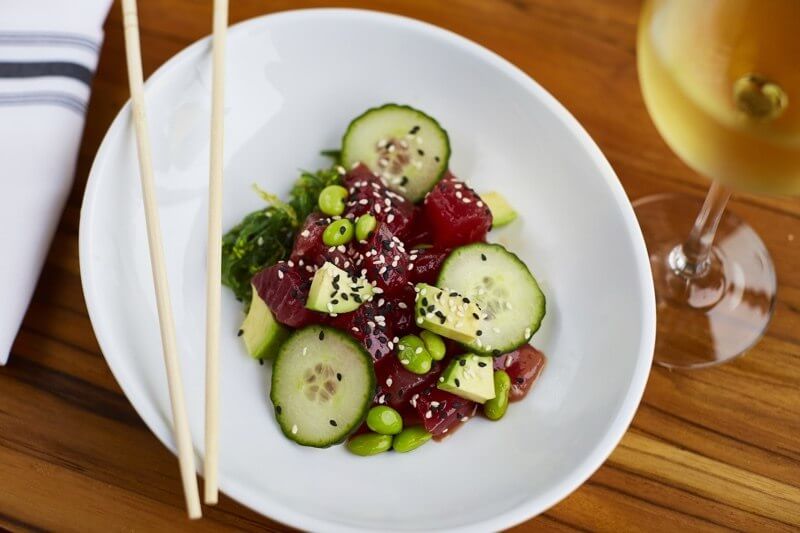 The rapa nui poke features tuna (or salmon — your choice), scallion, avocado, cucumber, edamame, seaweed, furikake, sesame soy and wontons. Amazing!