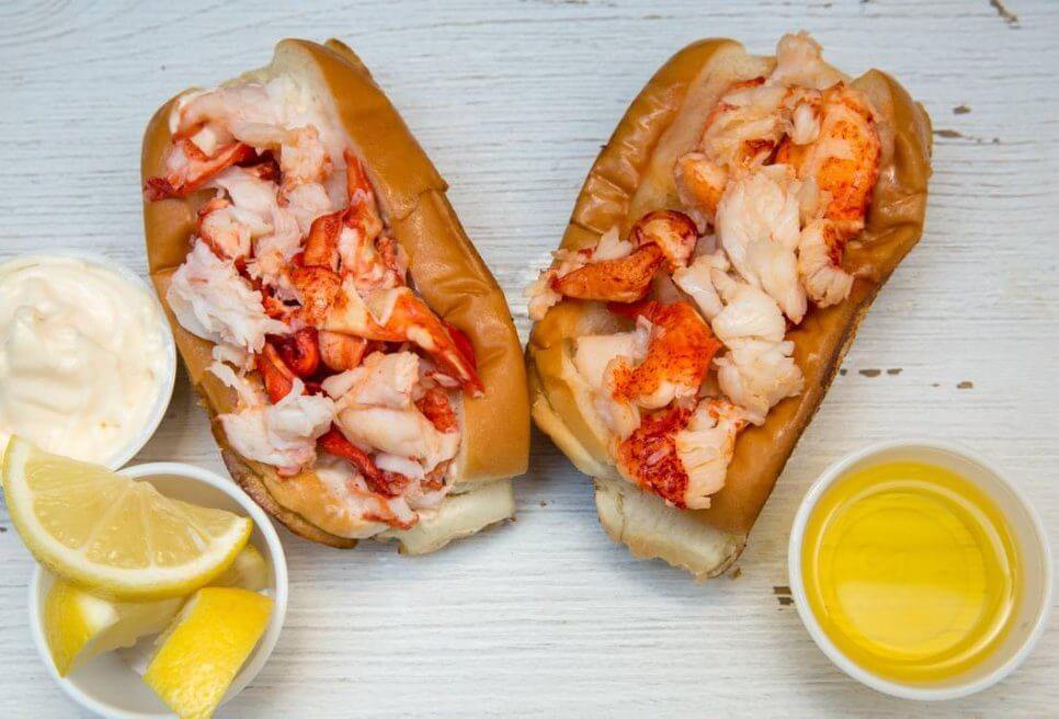 Cousins Maine Lobster rolls with sides of butter, lemon, and mayo