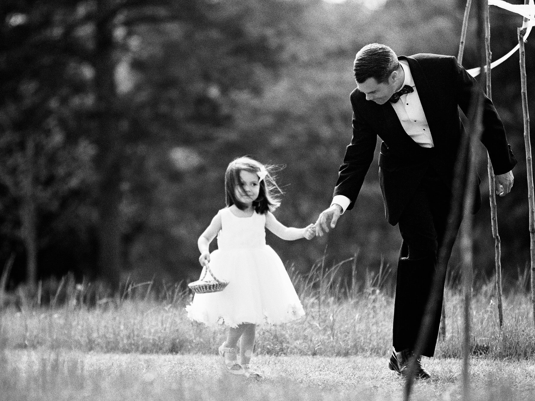 A sweet flower girl rushes down the aisle.