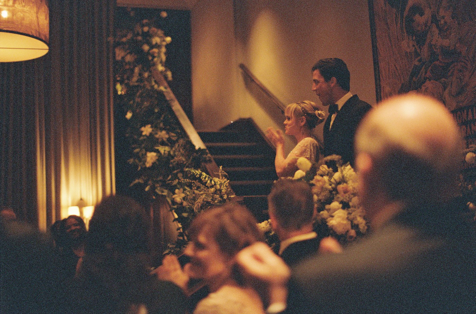 Marie and Edward come down the stairs to greet their happy crowd of well-wishers.
