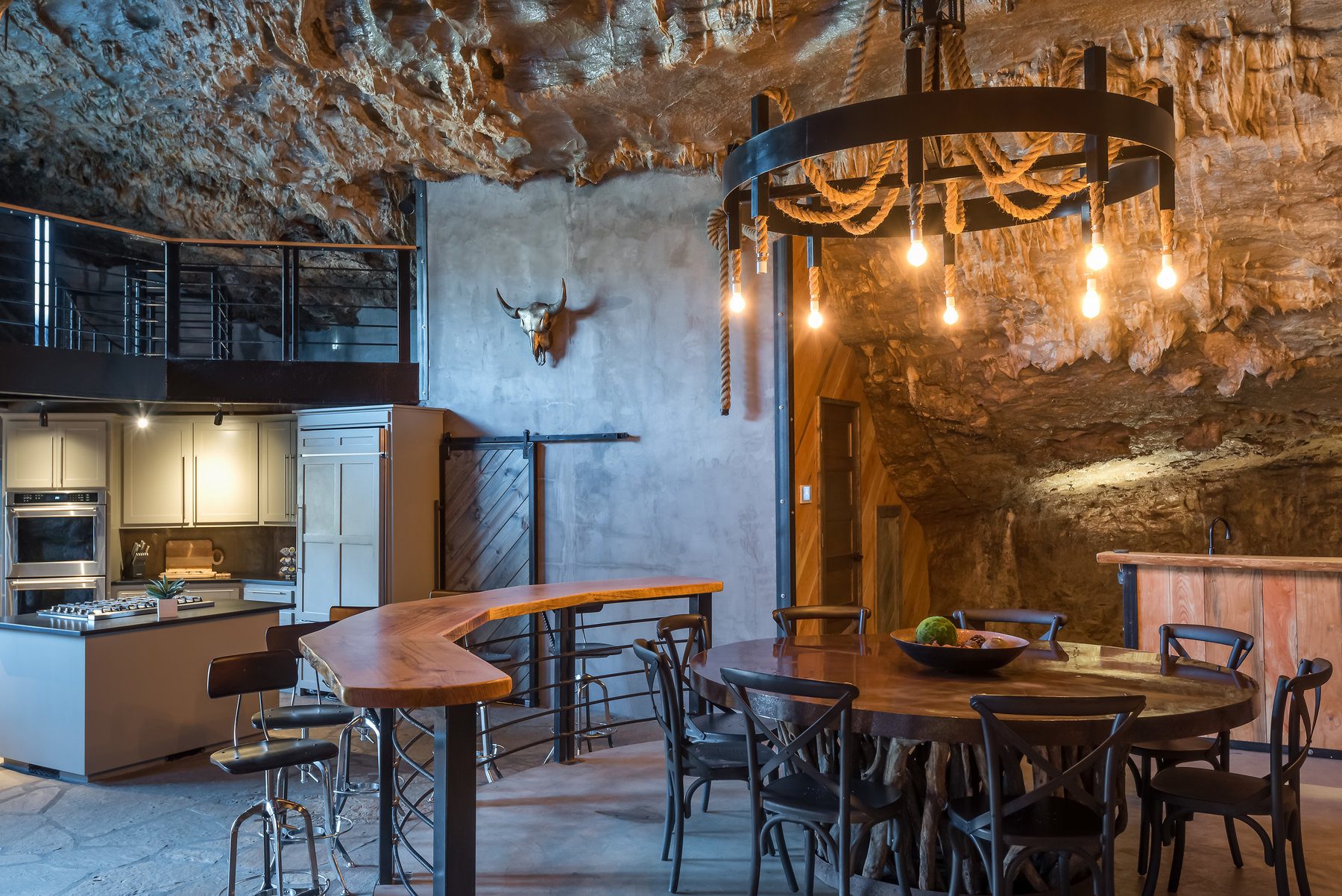 The spacious kitchen and dining areas include double ovens, a separate bar and counter seating and impressive fixtures — all inside a cave!