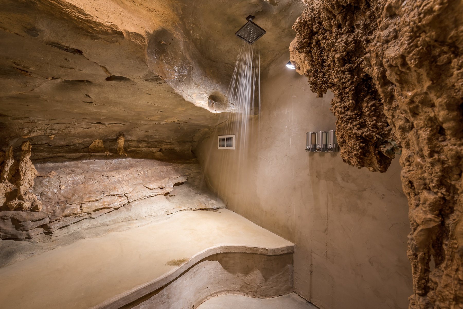 The master suite features a waterfall shower in a decidedly cave-like setting. Oh wait ...