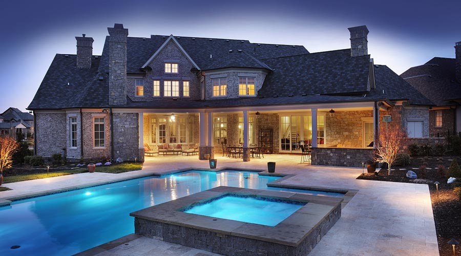 LED lighting in the pool creates a fun, family atmosphere in the backyard and transitions the space from daytime to nighttime. The broad covered porch offers plenty of room for grilling and for family get-togethers, backyard barbecues, birthday parties and more. “The whole softball team can come over and enjoy the pool and the fun lighting,” Brandon says.