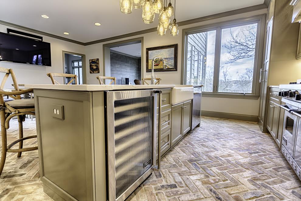 A wine refrigerator and cabinets in the kitchen's island add storage without taking up extra space. A wine refrigerator and cabinets in the kitchen's island add storage without taking up extra space.