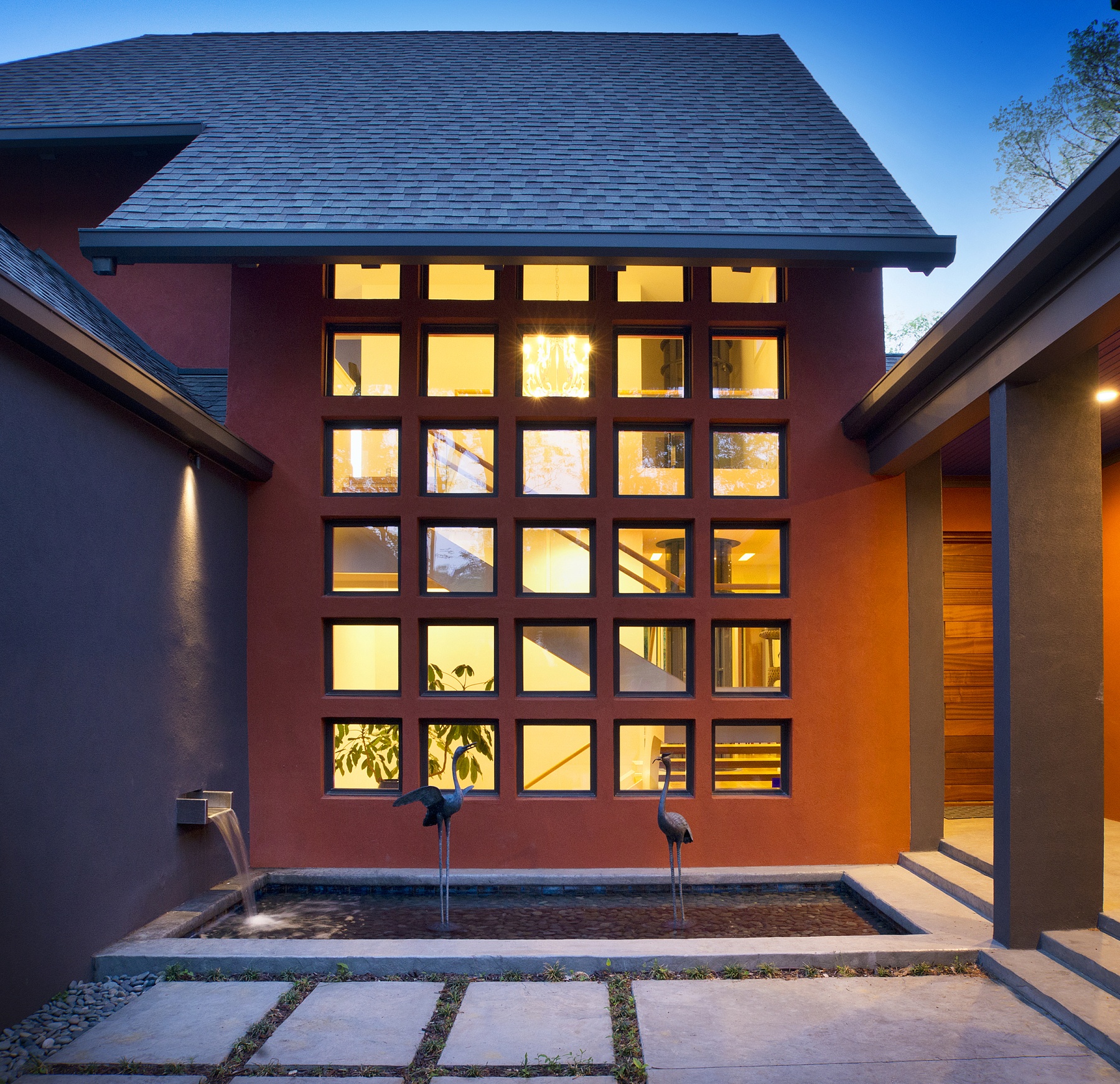 Set just off the front entry, a water feature incorporates a pair of bronze crane sculptures, turning the space into a gallery, zen garden and welcoming entryway all in one. Art – particularly art that pairs well with the architecture, as in this Asian-inspired space – is a great way to add distinction and personality to an outdoor area, Brandon says.