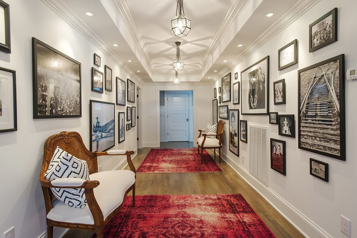 The interior hallway of this historic home features beautiful hardwoods accented with tasteful accent rugs to help guide guests into the home.