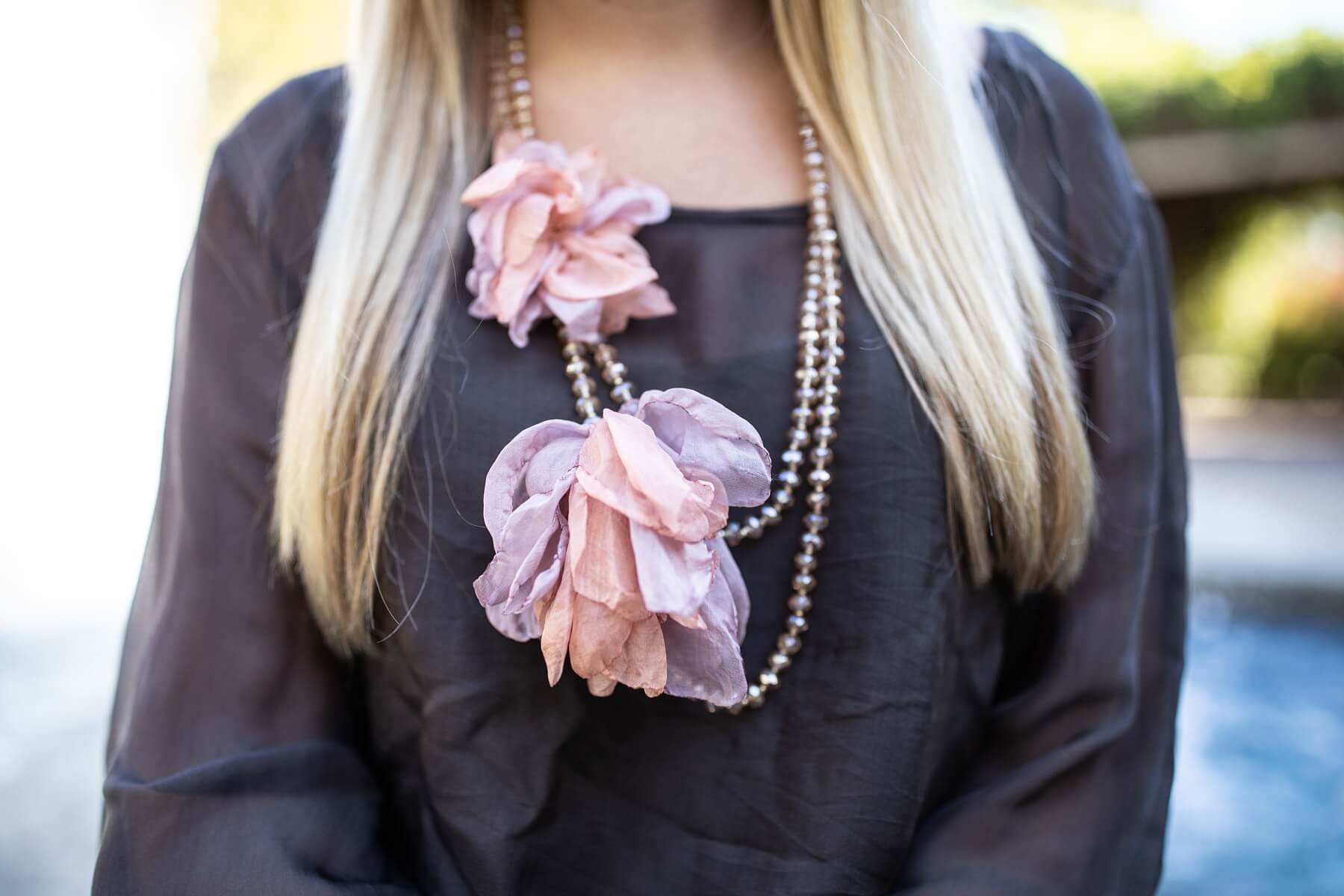 A grey blouse with a pop of pink adds color to Katie's outfit. 