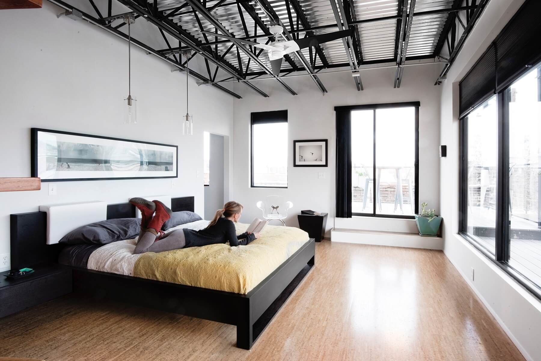 Clean lines and walls of light with access to a surrounding porch create a rejuvenating refuge in this mostly black-and-white master bedroom. Image: Liesa Cole