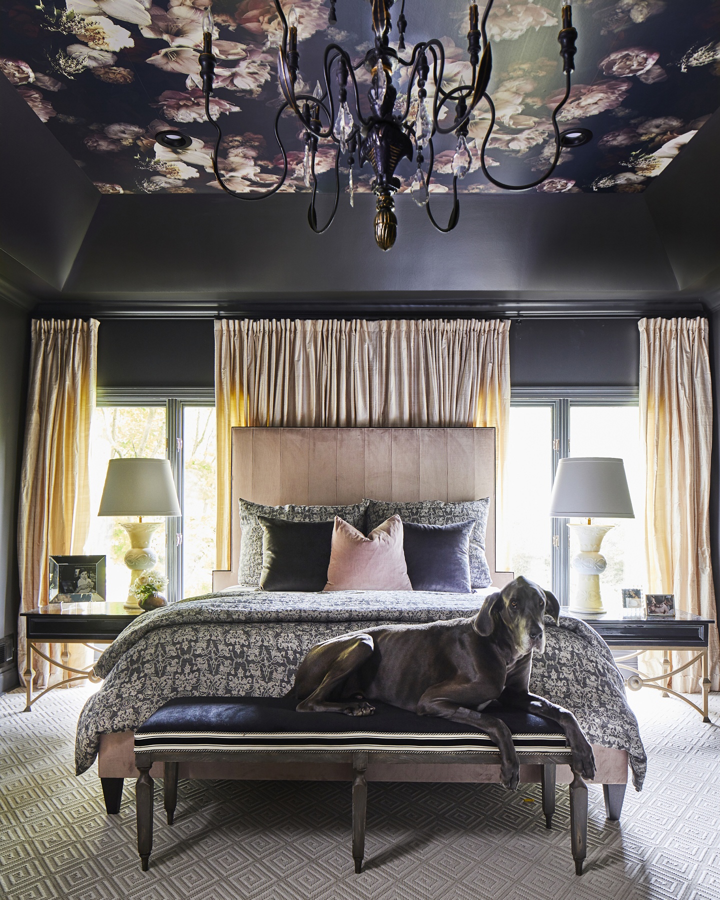 Pale pinks are interwoven through this black bedroom, which is accented by a breathtaking wallpaper of beautiful blooms in the same color palette.