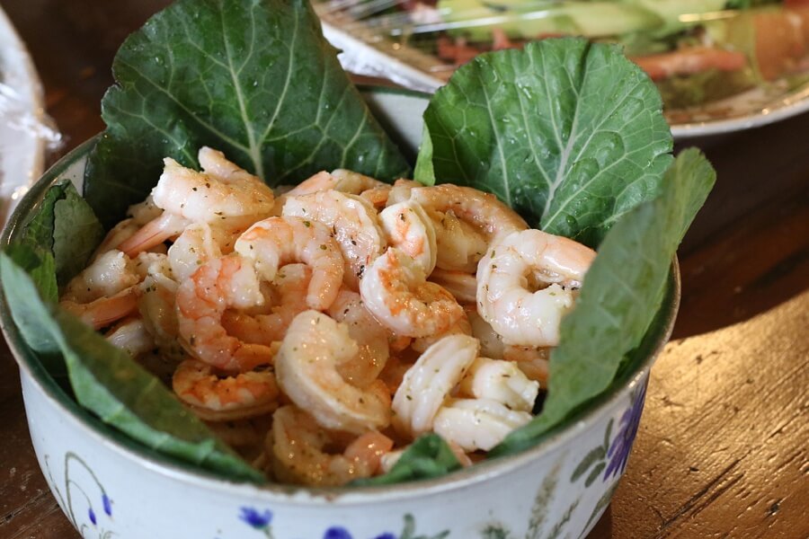 Shrimp in a bowl with lettuce.