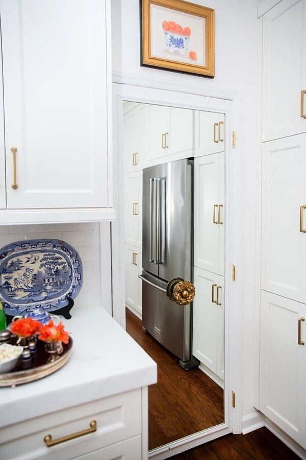 As a clever touch, the pantry door is mirrored, with an elegant gold tie-back (usually used for curtains) in place as a doorknob. pantry design details