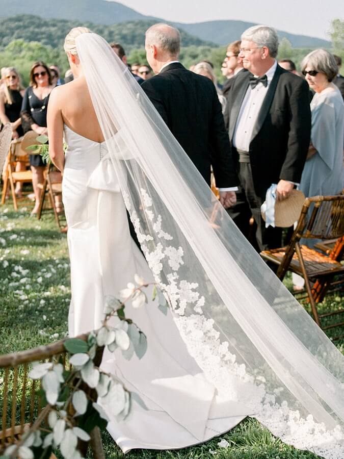 "The statement bow on the back was something my mom insisted I add, and moms are always right. It felt complete and very Vogue to me!" Lauren says. We agree. Back of wedding dress