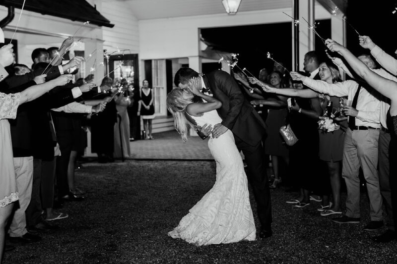 A kiss amidst sparklers at a Pursell farms wedding