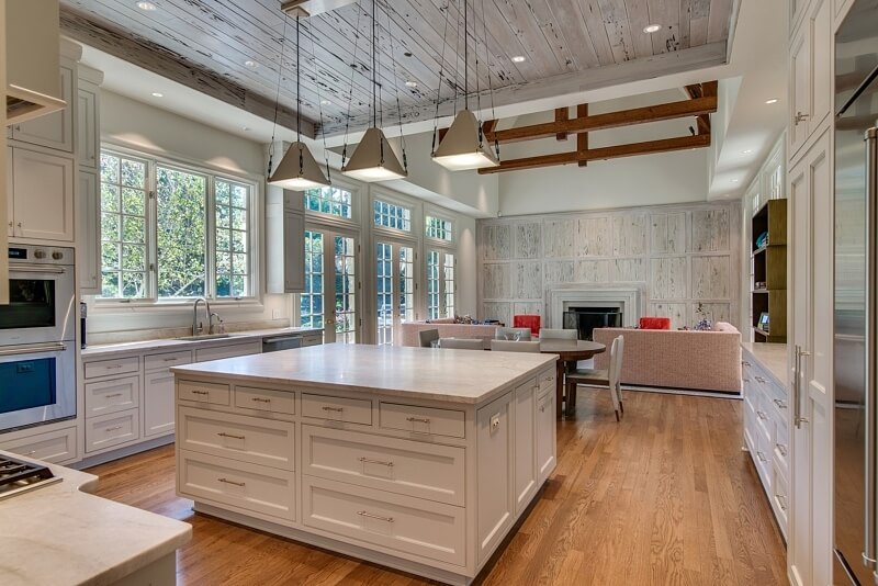 Mark tells us, "The rustic yet elegant Pecky Cypress transformed the once boring fireplace and added a sophisticated statement to the kitchen." Image: Trace Ventures remodeled kitchen