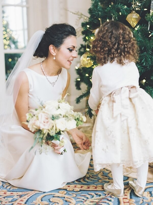 At this Nashville holiday wedding, the Christmas decor was as delightful for the adults as it was the kids. The bride and flower girl appreciate the Nashville holiday wedding decor