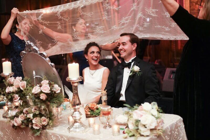 Danielle explains, "There is a great deal of symbolism in a traditional Persian sofreh. The bride and groom are seated at a table facing their guests. A mirror faces the couple and symbolizes eternity; you look into the mirror to symbolize looking into your future together as a married couple. Candlesticks are placed on either side of the mirror to represent passion for one another. The mirror and candlesticks are traditional gifts for the bride and groom's home. " Persian-influenced Nashville holiday wedding