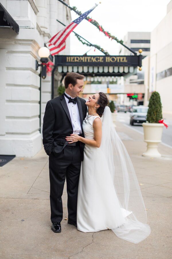 Matt and Danielle's love for Nashville is evident by both the proposal and wedding locations, the latter which took place at the beautiful Hermitage Hotel. Bride and groom at their Nashville holiday wedding at the Hermitage Hotel
