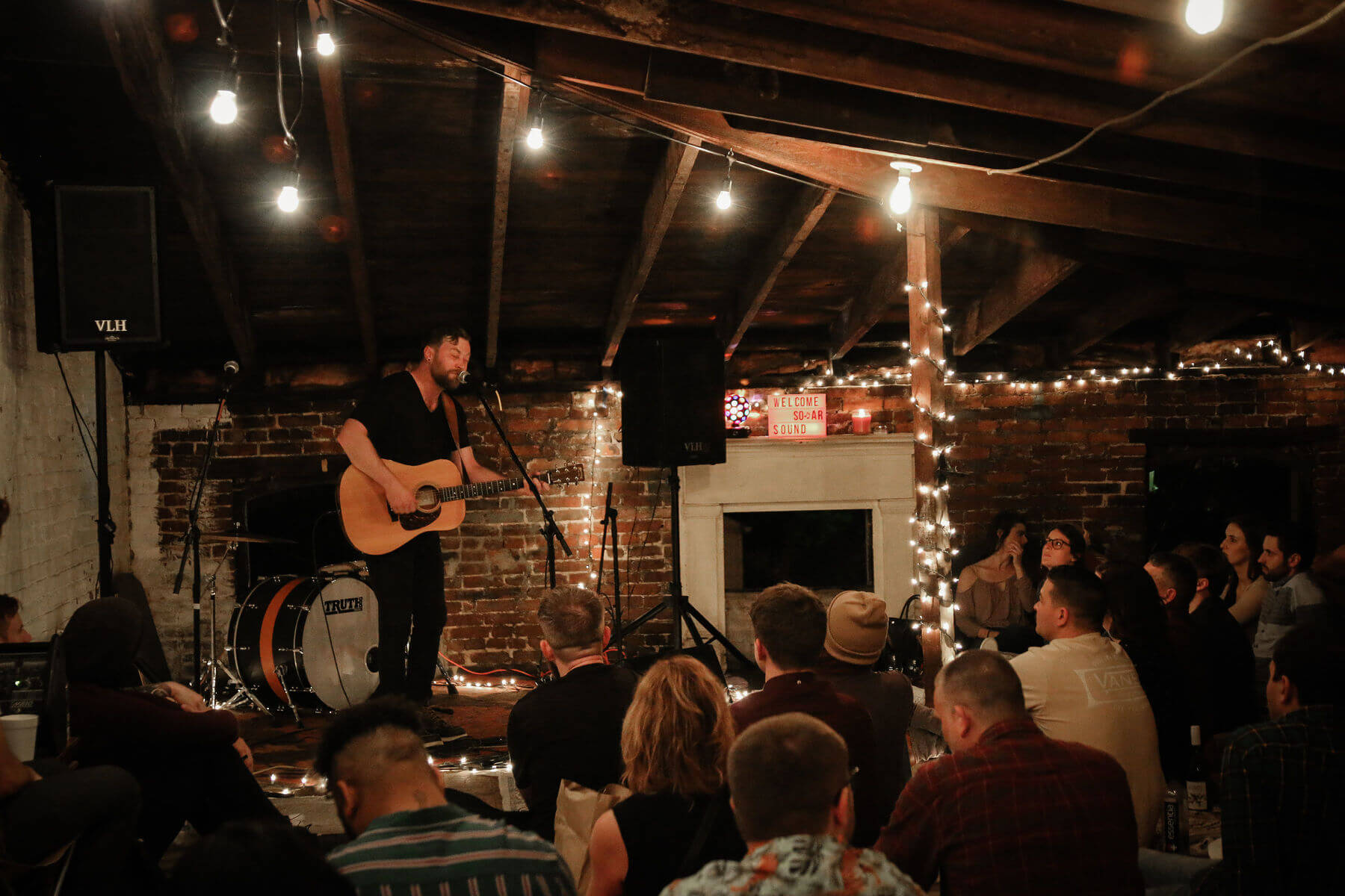 Jayme wants each Sofar show to be safe, comfortable and inviting, no matter the venue. Guitarist performing on stage