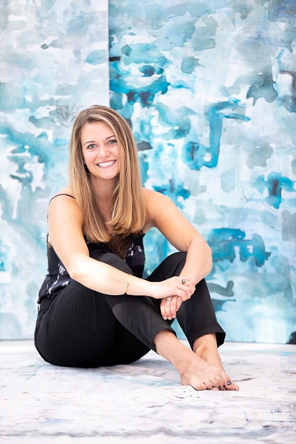 Katie credits her art education at Greater Atlanta Christian School for providing artistic inspiration. katie jones in front of art piece