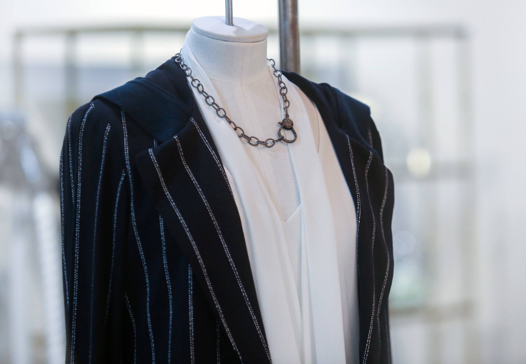 Pin-striped jacket with white top and necklace